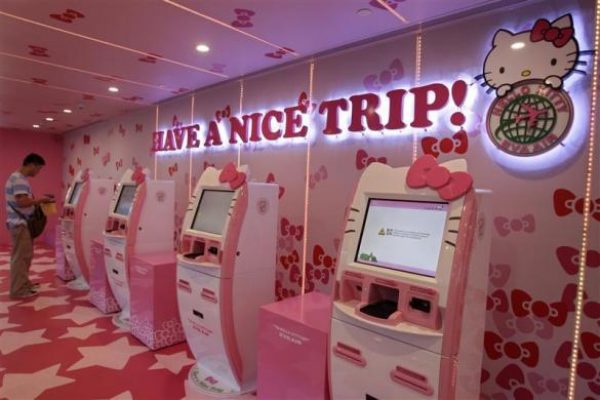 A passenger stands next to Eva Airlines' self check-in counters, which are decorated with Hello Kitty motifs, in Taoyuan International Airport, northern Taiwan