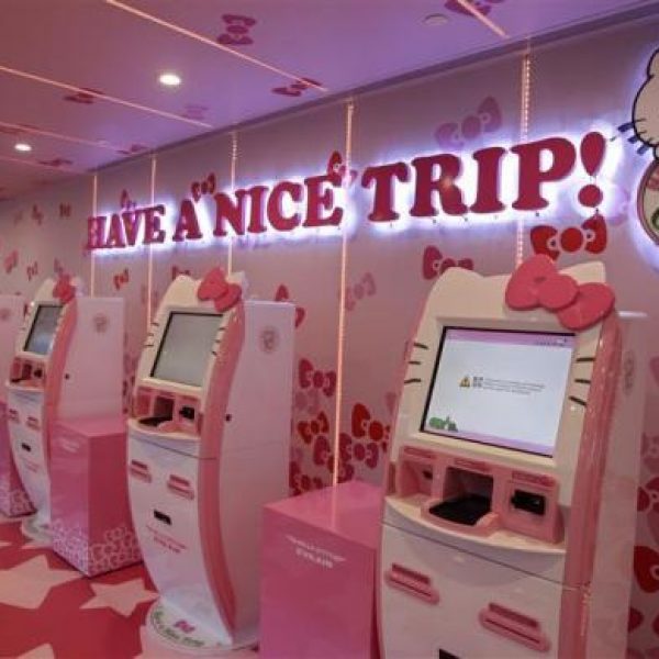 A passenger stands next to Eva Airlines' self check-in counters, which are decorated with Hello Kitty motifs, in Taoyuan International Airport, northern Taiwan