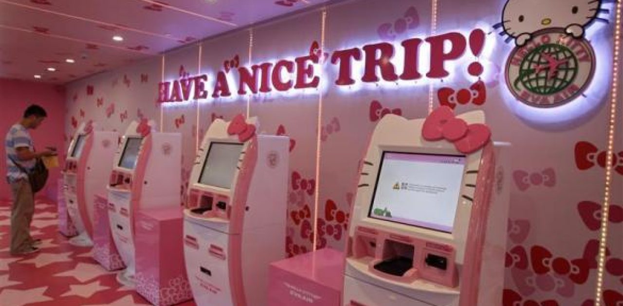 A passenger stands next to Eva Airlines' self check-in counters, which are decorated with Hello Kitty motifs, in Taoyuan International Airport, northern Taiwan