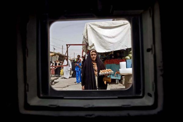 Photographs made from behind the window of an armored vehicle.