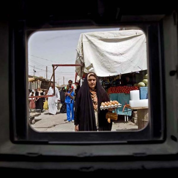Photographs made from behind the window of an armored vehicle.