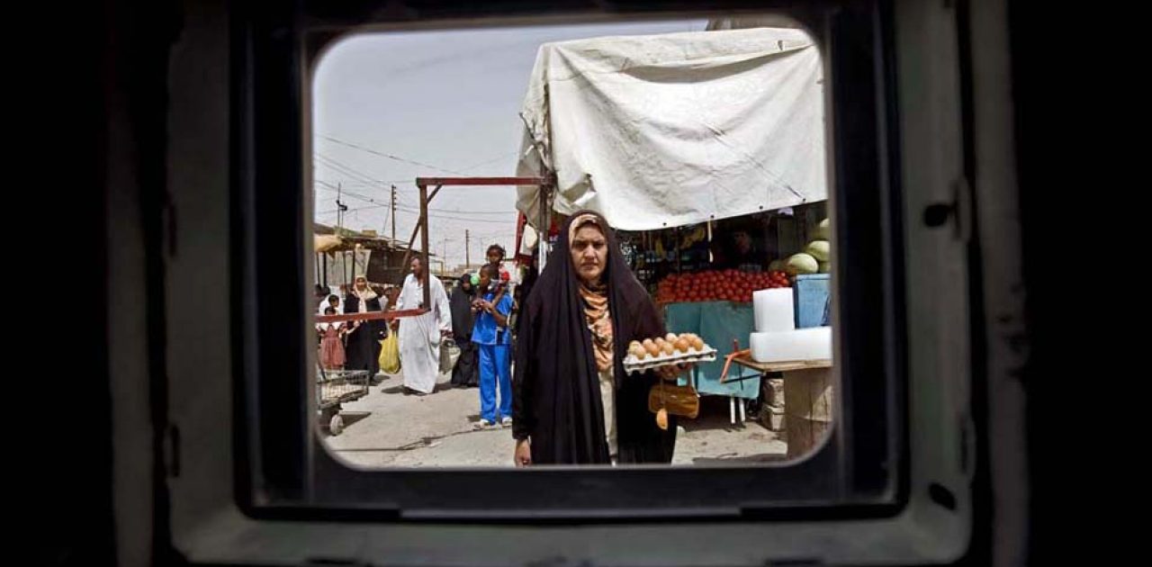 Photographs made from behind the window of an armored vehicle.